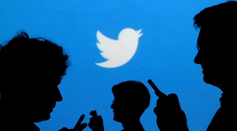 FILE PHOTO: People holding cell phones are silhouetted against a projected background with the Twitter logo in this illustrative photo taken September 27, 2013. REUTERS / Kacper Pempel / Illustration / File Photo (REUTERS)