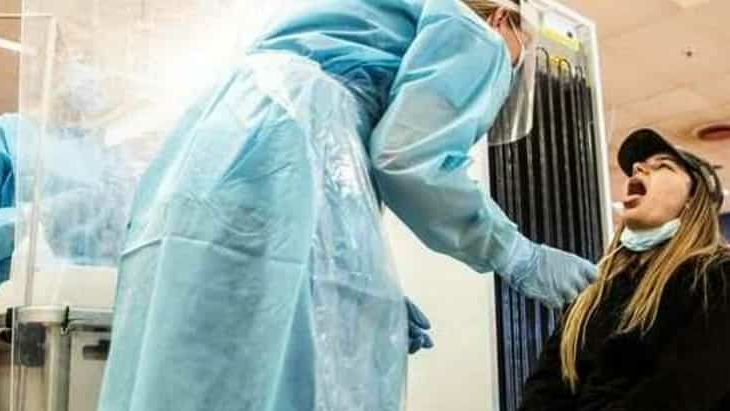 A health worker in the protection room takes a swab sample from a patient to be tested for coronavirus disease (COVID-19) at Herlev Hospital in Copenhagen, Denmark. (REUTERS)